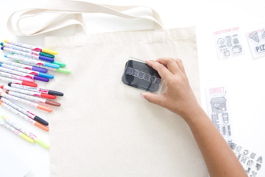 Use a few supplies to create a customized easy stamped canvas tote bag that you can color with fabric markers