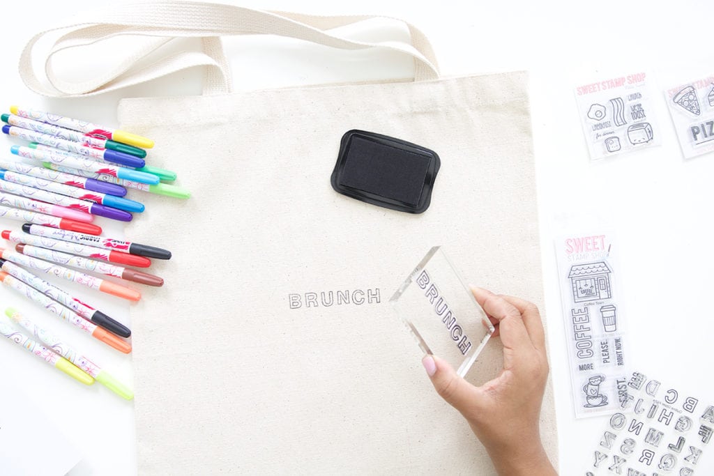 Use a few supplies to create a customized easy stamped canvas tote bag that you can color with fabric markers