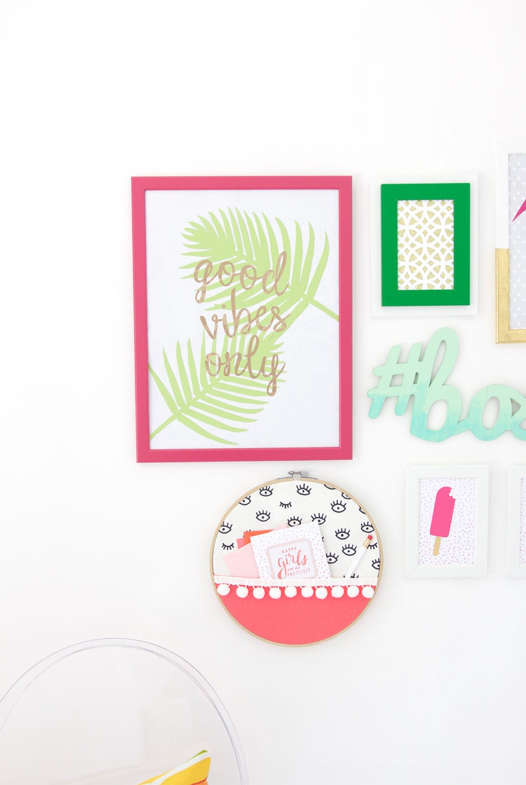 Gallery Walls can be intimidating, which is why I've avoided them until recently. Create your very own colorful Cricut Explore Gallery Wall with just a few cheap frames and some simple craft supplies.