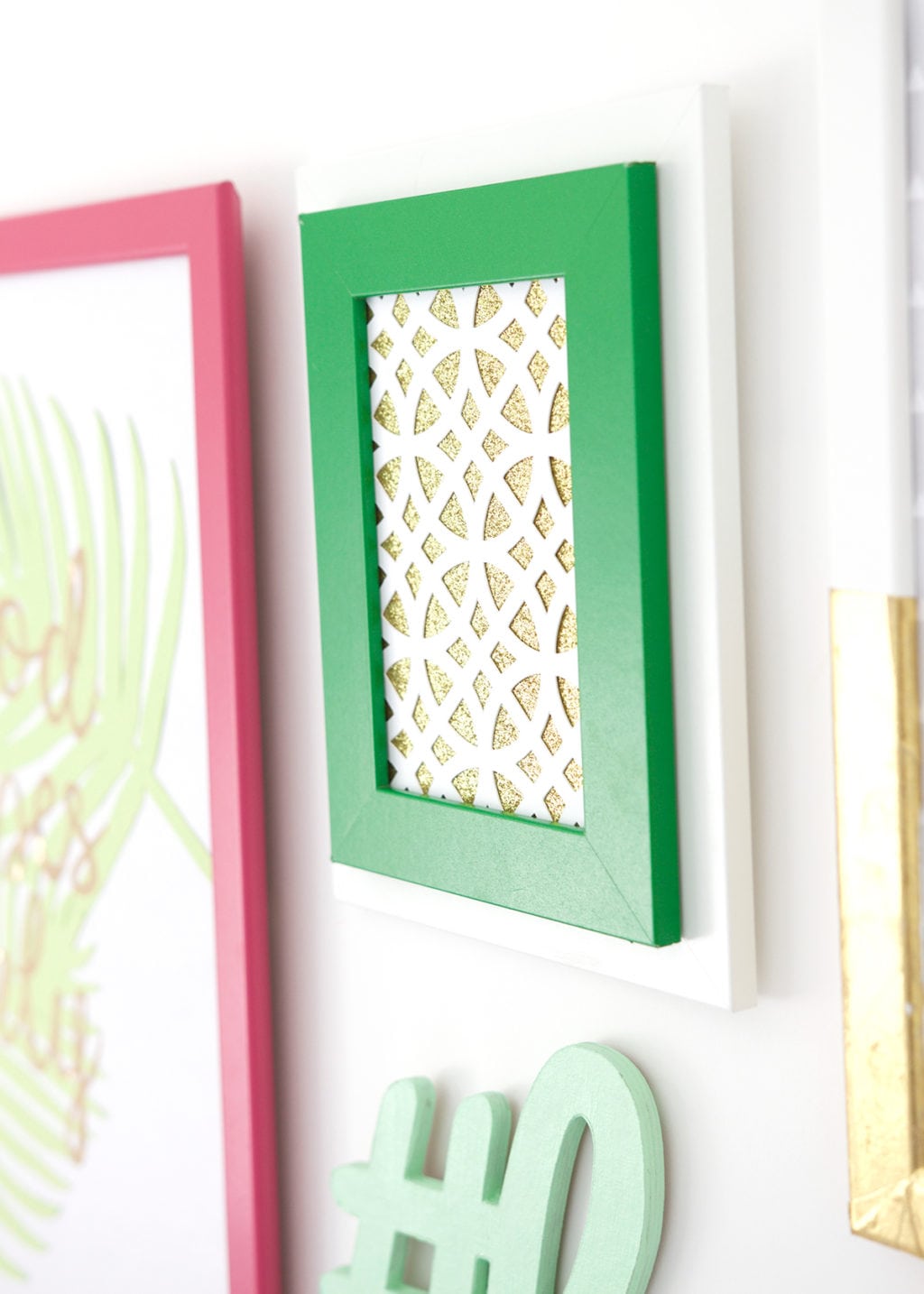 Gallery Walls can be intimidating, which is why I've avoided them until recently. Create your very own colorful Cricut Explore Gallery Wall with just a few cheap frames and some simple craft supplies.