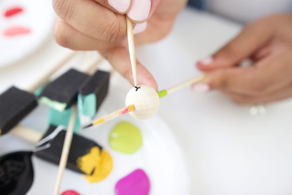 Grab some paint and learn how to paint wooden beads in a variety of different patterns..