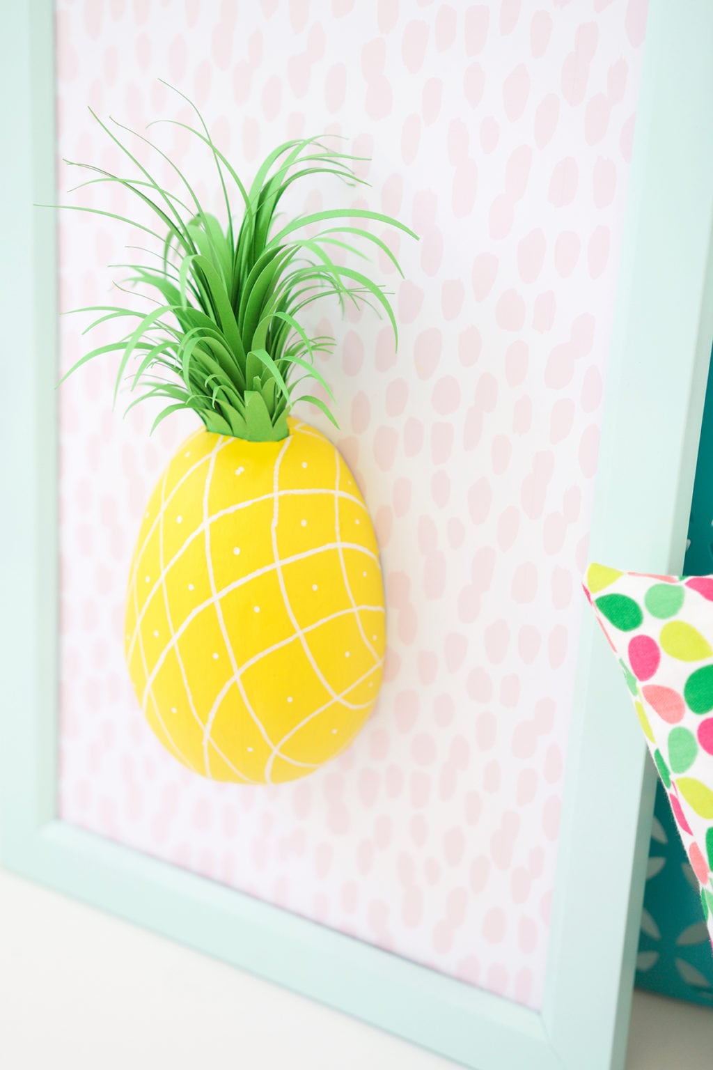 Mimic the look of taxidermy with a paper mache egg and some paint. This 3D diy paper mache pineapple wall art is a show stopper and a perfect addition to your gallery wall.