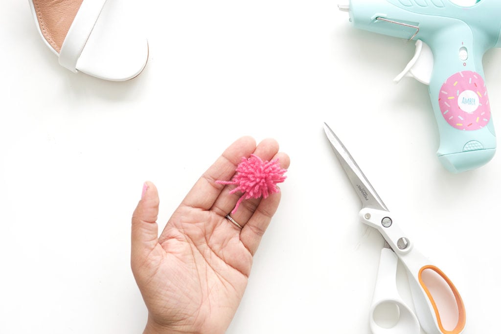 recreate this seasons hottest footwear by making your own DIY pom pom sandals. They will turn heads and save you a ton of money! 