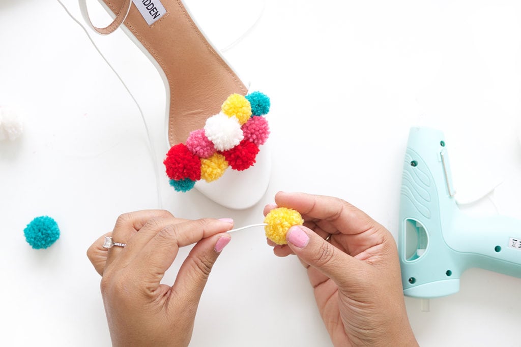 recreate this seasons hottest footwear by making your own DIY pom pom sandals. They will turn heads and save you a ton of money! 