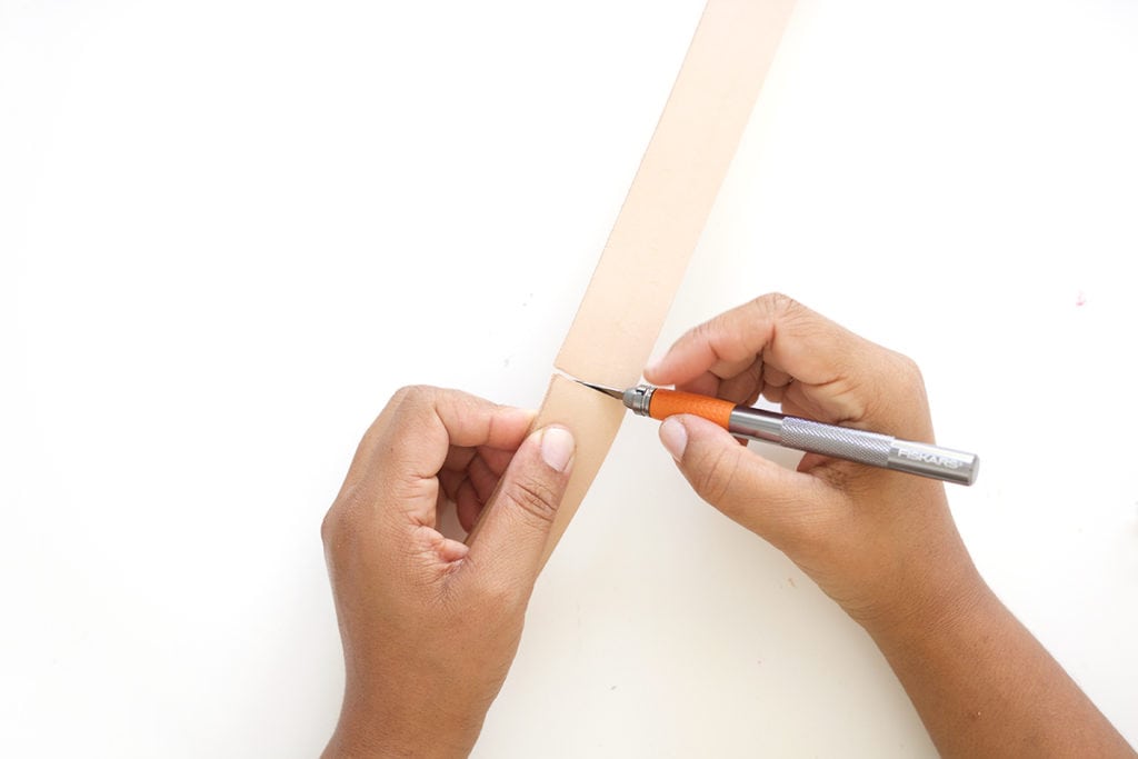 Transform a regular canvas tote bag into a DIY Leather Strap Canvas Tote Bag with the addition of leather and a few basic crafting supplies.