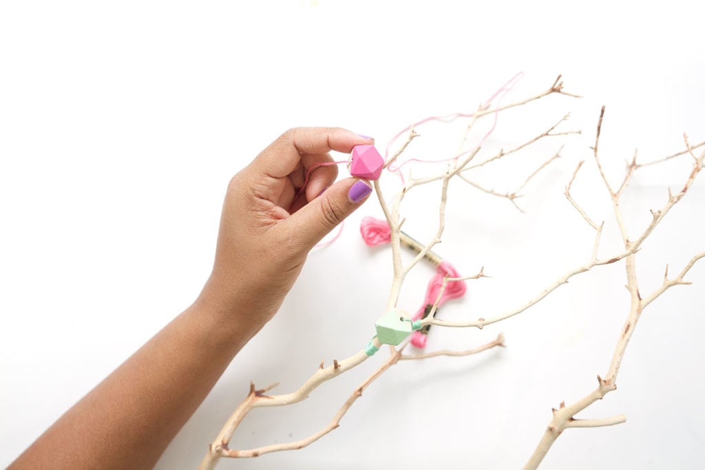 This painted wood bead manzanita branch is a funky take on the beauty of nature! A crafty way to use your painted wooden beads with a few basic supplies. 