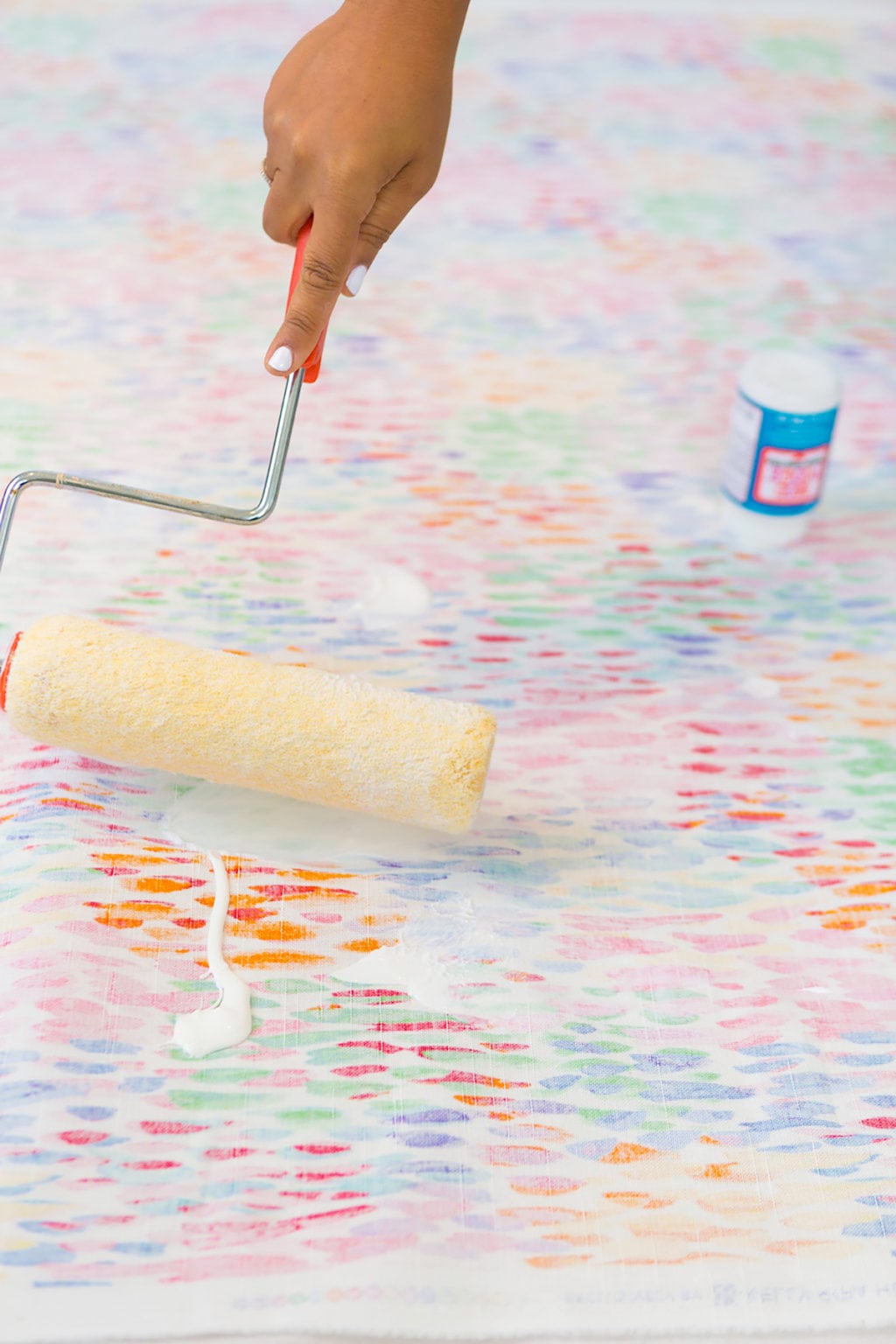 Large area rugs can be pricey! Follow this tutorial on how to turn a regular piece of fabric into a DIY Mod Podge Fabric Rug. It's totally customizable and afforable. 