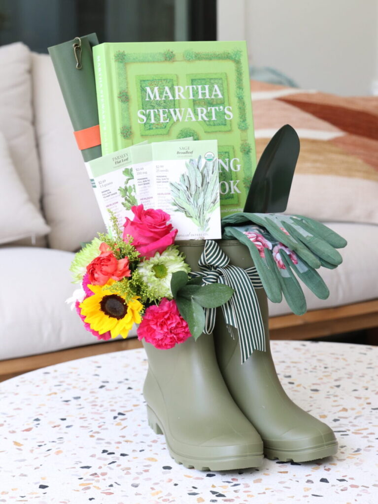 Rain boots with florals and garden-themed gifts inside