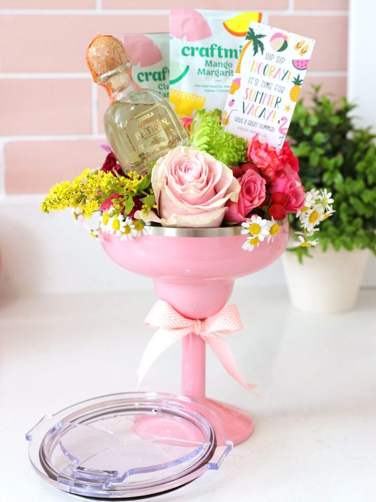 Travel margarita glass with florals and margarita drink mixers inside 